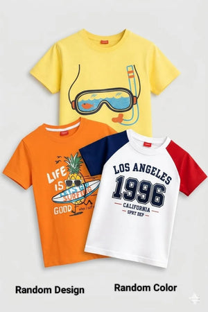 Three kids' short-sleeve t-shirts displayed together on a light gray background with the text 'Random Design' and 'Random Color' below. The shirts are yellow with a snorkel and goggles graphic, orange with a pineapple graphic and 'Life is Good' text, and white with navy sleeves and 'Los Angeles 1996' text.